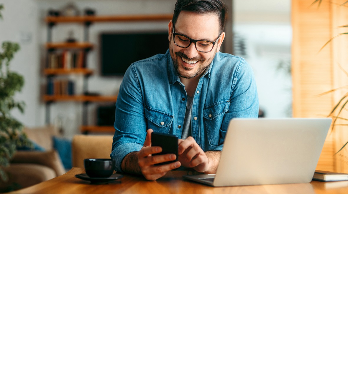 lady and man next to each other looking down at an iphone smiling