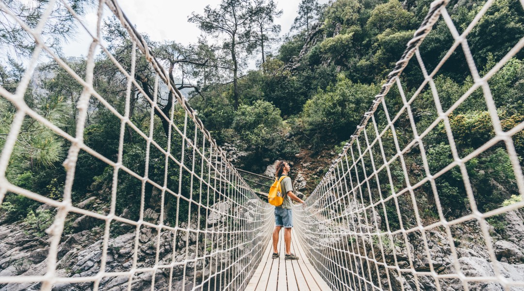 Man standing in the middle of a bridge in the outdoors