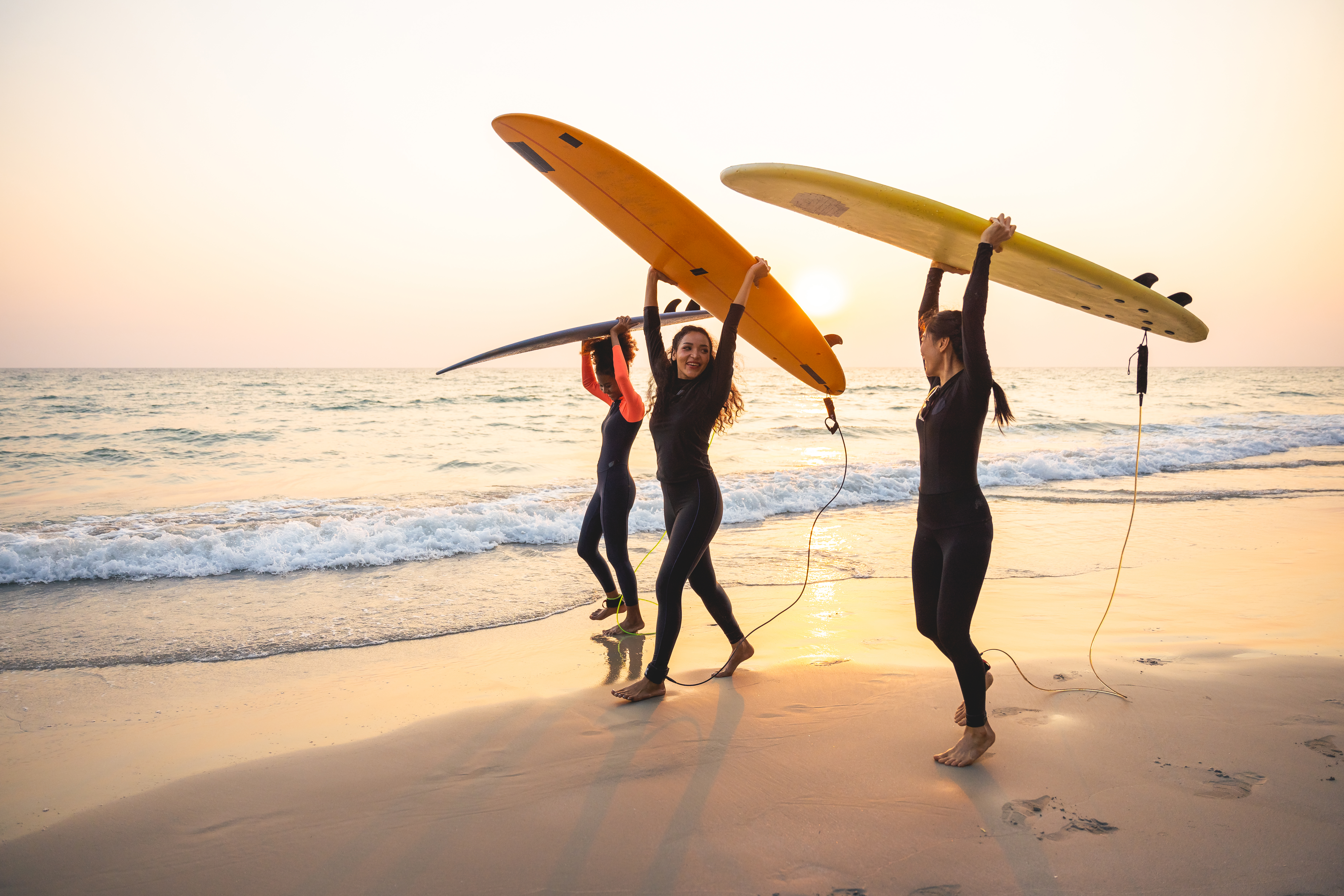 Group of female surfers walking on the beach Group of female surfers walking on the beach